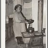 FSA (Farm Security Administration) client making bread in farm home. Sabine Farms, Marshall, Texas