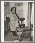 FSA (Farm Security Administration) client making bread in farm home. Sabine Farms, Marshall, Texas