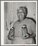 Wife of FSA (Farm Security Administration) client with home-canned vegetables. Sabine Farms, Marshall, Texas