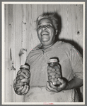 Wife of FSA (Farm Security Administration) client with home-canned vegetables. Sabine Farms, Marshall, Texas