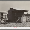 Shed and corner of house on farm unit. Sabine Farms, Marshall, Texas
