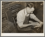 Bootmaker putting last and sole into upper part of boot. Boot shop, Alpine, Texas