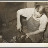 Boot maker putting lower part of boot around the last for fitting. Boot making shop, Alpine, Texas