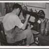 Repairing cowboy boots in boot shop. Alpine, Texas