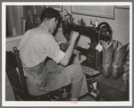 Repairing cowboy boots in boot shop. Alpine, Texas