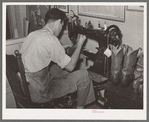 Repairing cowboy boots in boot shop. Alpine, Texas