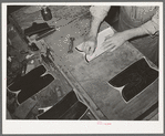 Transferring pattern for stitching on the uppers of the boots. Bootmaking shop, Alpine, Texas