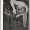 Rivet work in saddle repair shop. Alpine, Texas