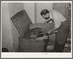 Selecting a piece of leather from the tempering chest. Cowboy boot shop, Alpine, Texas