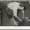 Cutting out of the sole of the boot from pattern traced from last. Bootmaking shop, Alpine, Texas