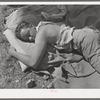 Son of the owner of the ranch resting after the roundup. Cattle ranch near Marfa, Texas