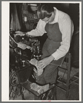 Repairing a pair of child's cowboy boots in saddle shop. Alpine, Texas
