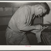 Hand skiving of leather. Saddle shop, Alpine, Texas