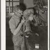 Repairing a saddle. Saddle shop, Alpine, Texas
