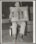 Mr. Henry Fletcher, owner of the "Walking X" Ranch, displaying awards won by his cattle. Marfa, Texas