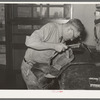 Repairing saddle. Saddle shop, Alpine, Texas