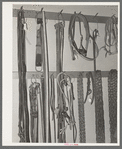 Cinch straps, bits, halters and chains in ranch supply store. Alpine, Texas