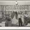 Cowboy examining saddle. Ranch supply store, Alpine, Texas