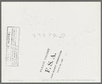 Cowboy examining saddle. Ranch supply store, Alpine, Texas