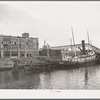 Tug at refinery dock. Port of Houston, Texas