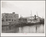 Tug at refinery dock. Port of Houston, Texas
