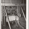 Placing bale of cotton into compressing unit. Compress, Houston, Texas. After going through the compress the bale of cotton is about one third its original size
