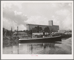 Flour mill and tug. Port of Houston, Texas