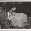 Negro women cleaning up damaged bales of cotton. Compress, Houston, Texas