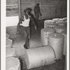 Rolling round bale of cotton at compress. Houston, Texas. These are not full bales