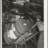 Removing bale of cotton from conveyer. Compress, Houston, Texas