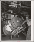 Removing bale of cotton from conveyer. Compress, Houston, Texas