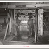 Negro laborers placing bands around compressed bale of cotton. Compress, Houston, Texas