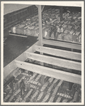 Storing bales of cotton into hold of freighter for export. Notice the different levels. Port of Houston, Texas