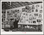 Women looking at art exhibit at Gonzales County Fair. Gonzales, Texas