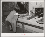 Looking at an exhibit of needle work at Gonzales, Texas, county fair