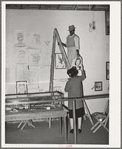 Taking down pictures display in the children's exhibit at the Gonzales County Fair, Texas