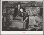 Packing exhibits to be returned to their owners during the closing hours of the fair. Gonzales, Texas