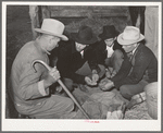 Men and boys examining seed at Gonzales County Fair. Gonzales, Texas