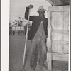 Worker in the show barns at the Gonzales County Fair. Gonzales, Texas