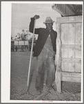 Worker in the show barns at the Gonzales County Fair. Gonzales, Texas