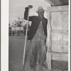 Worker in the show barns at the Gonzales County Fair. Gonzales, Texas