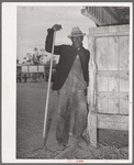 Worker in the show barns at the Gonzales County Fair. Gonzales, Texas