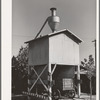 Wagon on scales at feed mill. Taylor, Texas. Ground feed is poured directly into the wagon from the hopper above