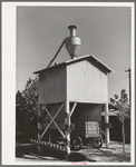 Wagon on scales at feed mill. Taylor, Texas. Ground feed is poured directly into the wagon from the hopper above