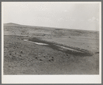 Stock water dam and waterhole on ranch near Marfa, Texas