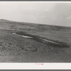 Stock water dam and waterhole on ranch near Marfa, Texas