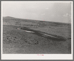 Stock water dam and waterhole on ranch near Marfa, Texas