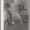 Burning out horns of calf. Cattle ranch near Marfa, Texas