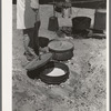 Cook of SMS Ranch making bread in Dutch oven. Near Spur, Texas