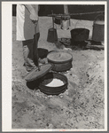 Cook of SMS Ranch making bread in Dutch oven. Near Spur, Texas